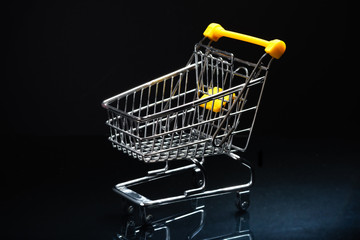 Close-up of shopping carts on black background.Trolley, Sale concept.Empty grocery shopping cart. Isolated over black background.