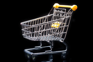 Close-up of shopping carts on black background.Trolley, Sale concept.Empty grocery shopping cart. Isolated over black background.
