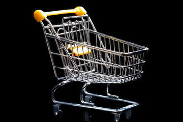 Close-up of shopping carts on black background.Trolley, Sale concept.Empty grocery shopping cart. Isolated over black background.