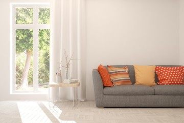 Stylish room in white color with sofa and summer landscape in window. Scandinavian interior design. 3D illustration