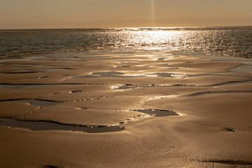 Sunset at low tide on the beach in France at the Atlantic Ocean