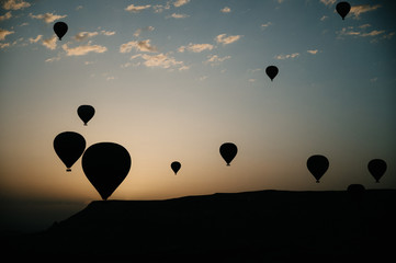 Naklejka premium Hot air balloons landing in a mountain Cappadocia Goreme National Park Turkey.