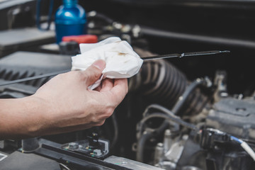 Services car engine machine concept, Automobile mechanic repairman hands checking a car engine automotive with oil level in the engine transportation, car service and maintenance