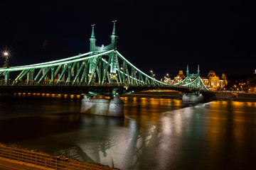 Freedom Bridge in Budapest, Hungary.Night. Reflections of lights on the water.