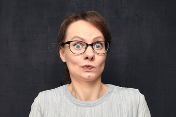 Portrait of puzzled young woman with glasses