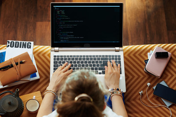young woman testing software and writing code