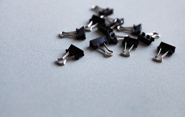 Metal office clips scattered on a white background