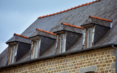 Slate roof and dormer windows in typical houses of French Brittany.
