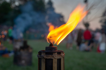 Burning flame of an outdoor torch at a party