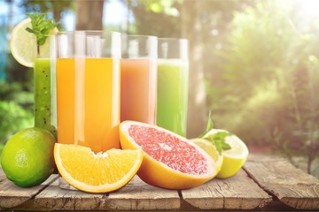 Tasty fruits and juice on wooden table