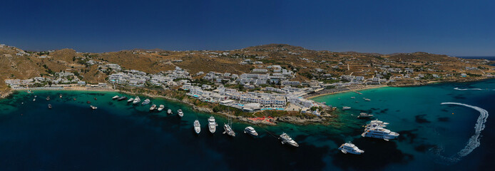 Aerial panoramic photo of famous turquoise clear sea celebrity sandy beach and bay of Psarou with...