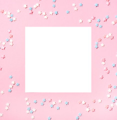 Little stars confetti on pink background. Holyday concept. Copy space for your text.