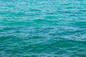 simple natural background picture of slightly wavy blue water surface 