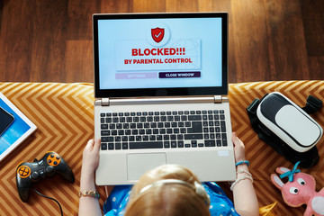 girl having access restriction by parental control on laptop