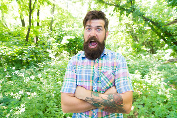 Naklejka na ściany i meble Summer vacation concept. United with environment. Man bearded hipster green trees background. Emotional nature lover. Guy relax in summer nature. Man handsome beard and mustache in summer forest