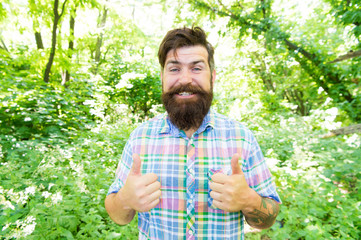 Naklejka na ściany i meble Summer vacation concept. Man bearded hipster green trees background. Emotional nature lover. Guy relax in summer nature. Man handsome beard and mustache in summer forest. United with environment