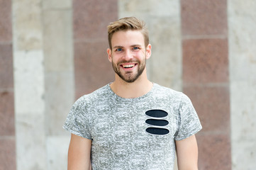 Perfect smile of a cheerful guy. Happy guy on urban outdoor. Bearded guy smiling in casual summer...
