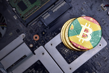 golden bitcoins with flag of grenada on a computer electronic circuit board. bitcoin mining concept.
