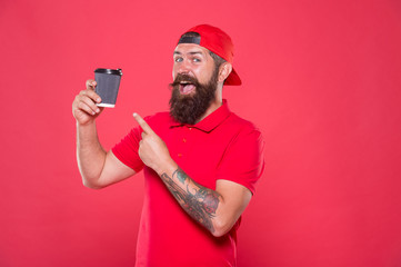 Barista prepared drink for you. Cheerful barista. Man bearded hipster red cap uniform hold paper coffee cup. Barista recommend caffeine beverage. Barista job position. Coffee shop staff wanted