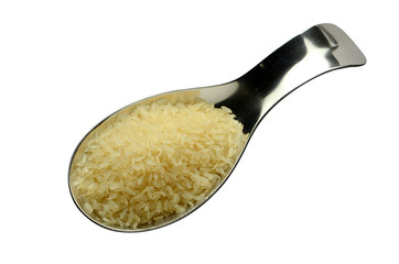 Raw polished rice in spoons on isolated background top view.