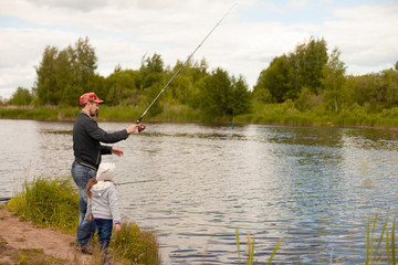 Dad and daughter fishing on lake