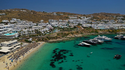 Aerial panoramic photo of famous turquoise clear sea celebrity sandy beach and bay of Psarou with...