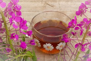cup of tea with blooming sally flowers on a wooden background