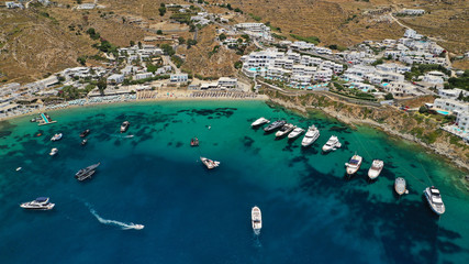 Aerial panoramic photo of famous turquoise clear sea celebrity sandy beach and bay of Psarou with...