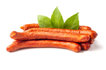 Dry smoked Sausages with basil leaves, macro, isolated on white background.