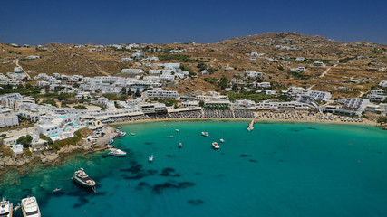 Aerial panoramic photo of famous turquoise clear sea celebrity sandy beach and bay of Psarou with...