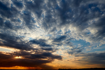Fototapeta premium Beautiful sunset - dark sky with clouds and sunlight