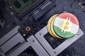 golden bitcoins with flag of kurdistan on a computer electronic circuit board. bitcoin mining...