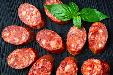 Fototapeta na wymiar A french saucisson - dry summer sausage on the black background.