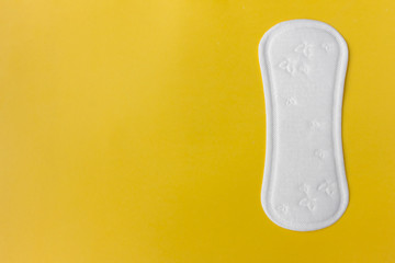 clean white menstruation pad pads daily during menstruation, lying on a yellow background with copy space, women on critical days, gynecological menstrual cycle