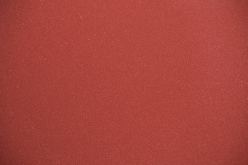 red abstract background, shiny metallic paint on surface with shiny sparkling