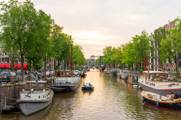 Amsterdam Canal with house boats at sunset