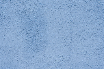 The brightly painted surface is covered with smoky dusty blue plaster. Background for copy space