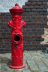 old fire hydrant against the brick wall