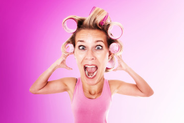 blond woman with bug head in curlers is screaming
