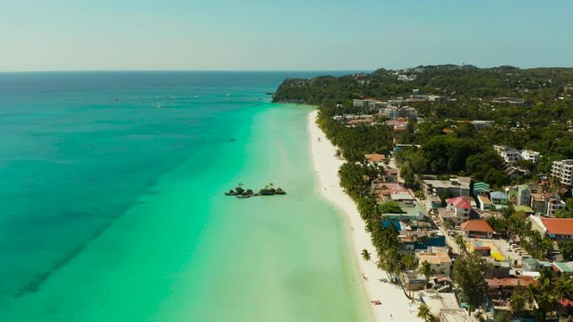 Tropical white sand beach, hotels near the blue lagoon and corall reef. aerial view, Boracay, Philippines. Seascape with beach on tropical island. Summer and travel vacation concept.