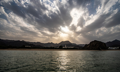 Sunset view of Muscat along the coast from a boat on the ocean