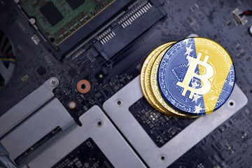golden bitcoins with flag of bosnia and herzegovina on a computer electronic circuit board. bitcoin...