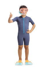 Boy waving and wearing a wetsuit, a diving mask and diving flippers