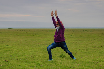 redhead woman practicing yoga