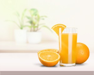 Glass of delicious orange juice on natural background