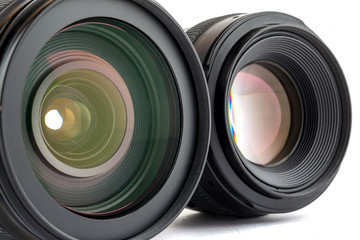 Two black photo lenses on white background