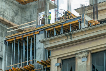 Builders install piles on the house. Home construction. Construction concept