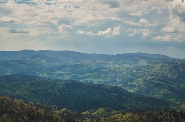 Amazing spring mountain landscape. Shadows and lights on the trees in the hills.
