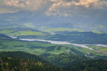 Beautiful mountain spring landscape. View of the Czorsztyn Lake and green valleys and hills.
