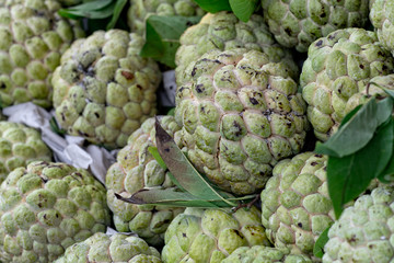 Fototapeta premium Sugar-apple fruit, also known as sweetsop, at market stall in Ho Chi Minh City in Vietnam.